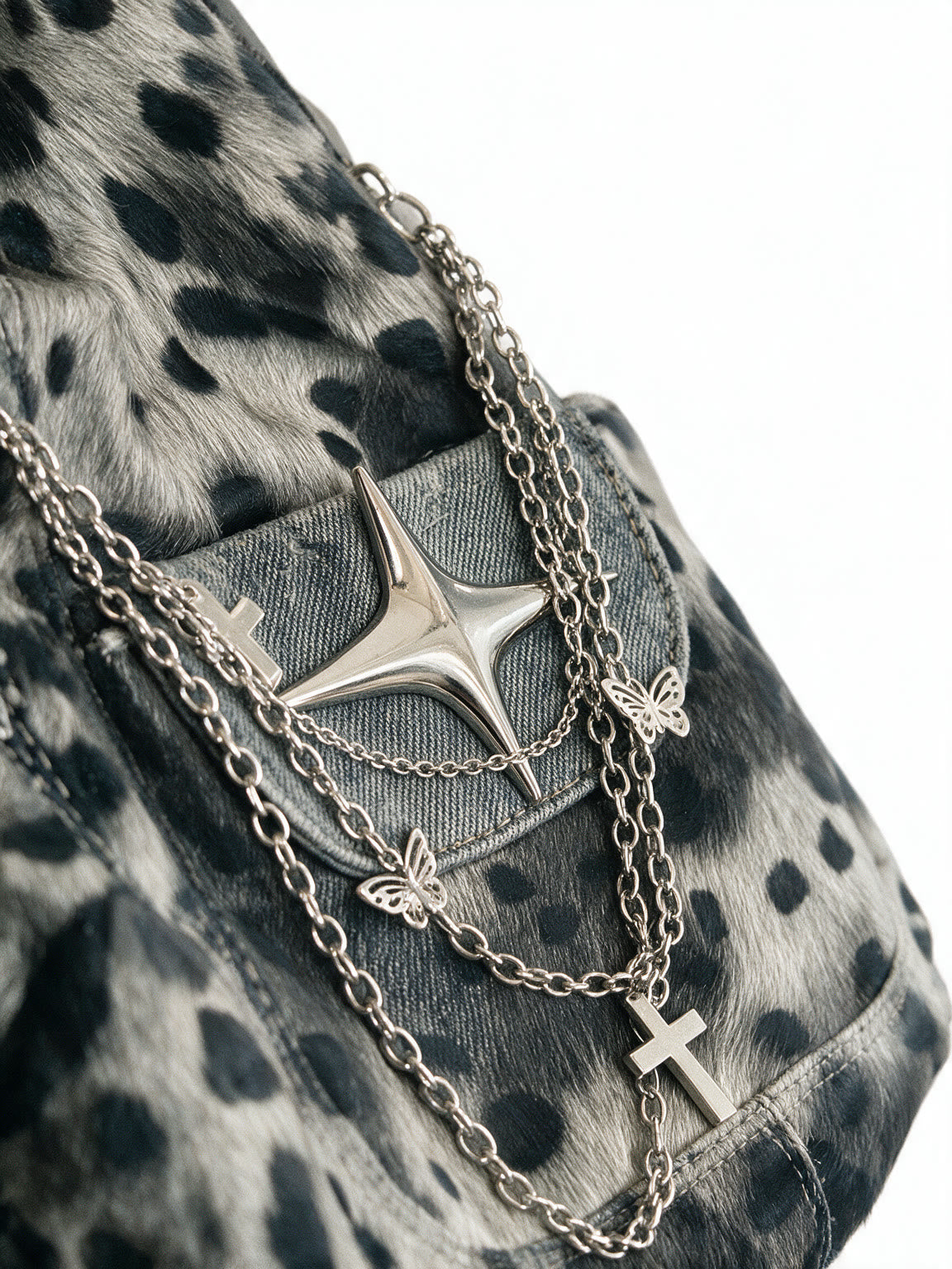 Grey leopard print hobo bag with silver chains and a star charm