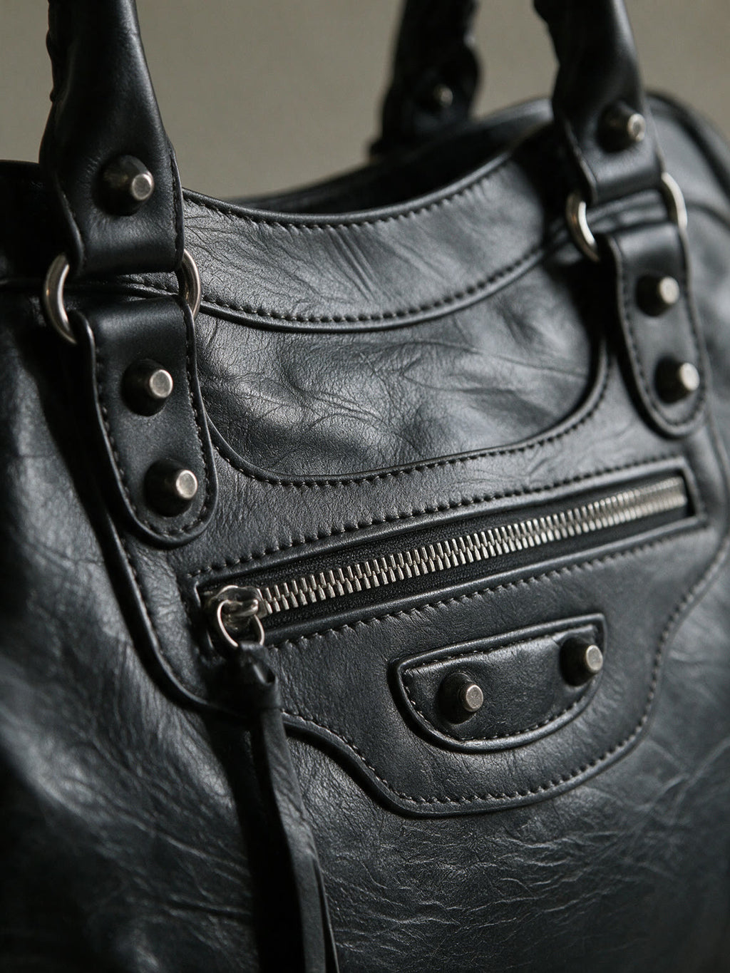 Washed black moto city bag with braided leather handles