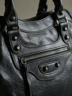 Washed black moto city bag with braided leather handles