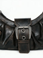Pleated black leather baguette bag with a centre buckle