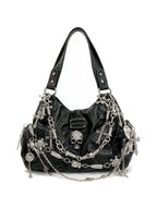 Black hobo bag covered in silver chains, skulls and spike charms