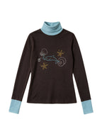 Brown turtleneck long sleeve top with pale blue cuffs