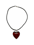 Red glass heart pendant on a black cord necklace