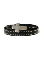 Black studded belt with a large silver cross