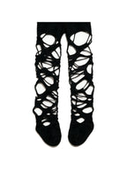 Black tights torn into ladders up both legs