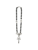Black bead rosary necklace with a bat and dagger pendant