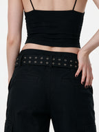 Black cargo flare trousers with rivets and a studded belt