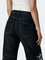 Black flare jeans with white filigree embroidery