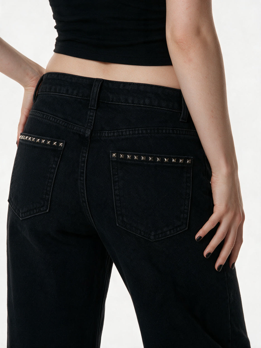 Black low rise flare jeans with a studded waistband