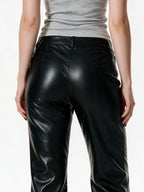 Black faux leather flare trousers with knee buckle straps