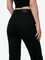 Black high waist flare trousers with a studded belt